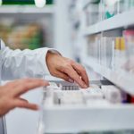 Pharmacies RUN OUT Of Life-Saving Medicines Across Country! Pharmacist organizing medication on a shelf