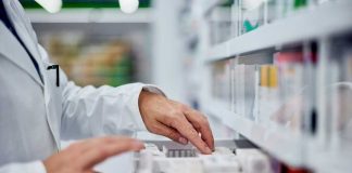 Pharmacies RUN OUT Of Life-Saving Medicines Across Country! Pharmacist organizing medication on a shelf