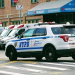 Cops Kid KILLED in Gang Crossfire Police car and ambulances outside emergency room entrance.