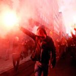 Maniac Sets Himself ON FIRE On U.N Headquarters Steps Crowd of protesters holding smoke flares in a city street