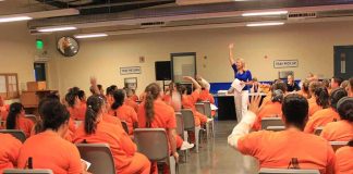 Last-Minute Gender Change BACKFIRES – Convict Denied Transfer! Group of inmates in orange uniforms attending a class in a prison hall