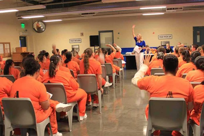 shutterstock_1413505286 Group of inmates in orange uniforms attending a class in a prison hall