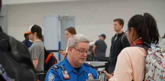 Airports Hand Security to Private Contractors tsa officer checks a traveler's documents at airport security
