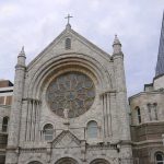 Arson Strikes Historic 140-Year-Old Church—Twice Stone church facade with large rose window and cross