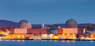 Nuclear Plant LEAKED – Chernobyl 2.0? nuclear power plant with two domed reactor buildings by water at dusk