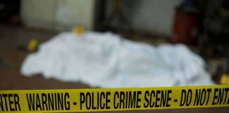 Body Found on Dem Reps Grass IDENTIFIED! crime scene tape in foreground with covered body in background