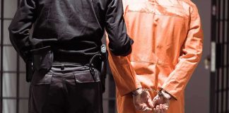 Paroled Offender TERRORIZES Entire Neighborhood Prisoner in orange jumpsuit handcuffed with guard standing beside