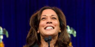 smiling woman speaking at a podium