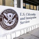 USCIS sign at a federal building entrance