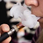 What Happens To People Who Vape While Using GLP1 Drugs Is Frightening Close-up of a person vaping, exhaling smoke clouds