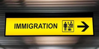 Immigration sign with arrow in airport