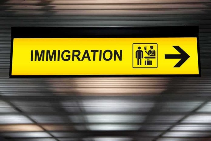 shutterstock_631851455 Immigration sign with arrow in airport