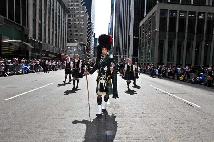 shutterstock_100112753 Participants in traditional Scottish attire marching in a parade on a city street