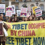 Tenzin Gyatso, Ip Ching, Christian Jones, and Colin David Jones among protesters holding Tibet banners
