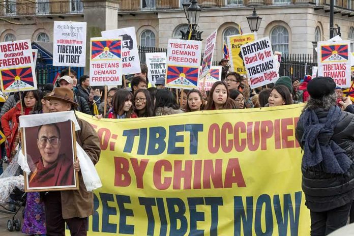 shutterstock_1043115364 Tenzin Gyatso, Ip Ching, Christian Jones, and Colin David Jones among protesters holding Tibet banners