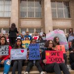 2 Teachers SLASHED in School Stabbing! Students holding protest signs on school steps