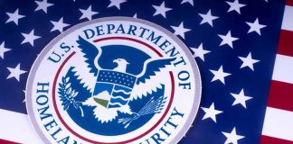 DHS Sends Four-Word Warning To Migrant Caravan U.S. Department of Homeland Security seal on American flag