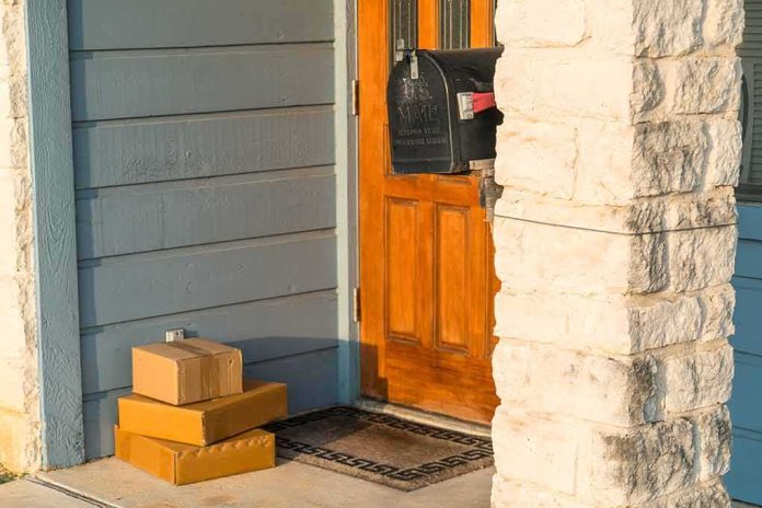 Packages stacked on a doorstep by a wooden front door
