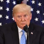 China Showdown: Trump’s Summit Gamble person at podium with microphone