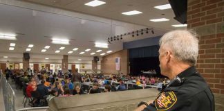 security officer overseeing a crowded school cafeteria
