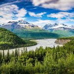 Catastrophic Flood KILLS 237, 1,300 Missing! Snow-capped mountains above a winding river and dense green forest