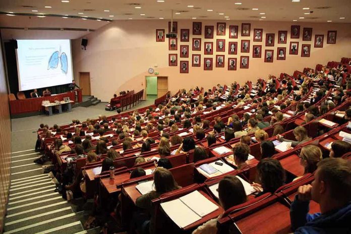 shutterstock_132834815 Students seated in a lecture hall listening to a presentation