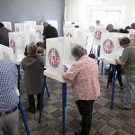SENATOR SLAMS SCOTUS: Compares Ruling to Terrorism! Voters fill out ballots at polling booths in a busy voting room
