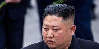 Kim Jong-Un looking to the side in a dark overcoat