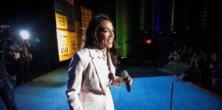 AOC Gets Destroyed in Fact Check on ‘Black Lynchings’ — This Is Humiliating Woman in a light suit holding a microphone on a stage