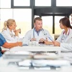 Doctors in a meeting at a hospital conference table