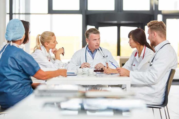 shutterstock_1527224705 Doctors in a meeting at a hospital conference table