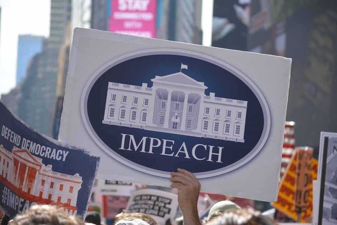 shutterstock_1529910779 Protest crowd holding an impeach sign with the White House emblem