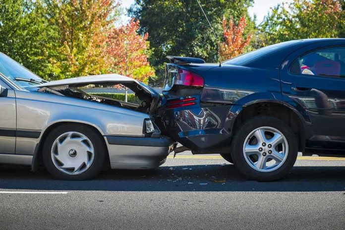 Two cars in a rear-end collision on a city street