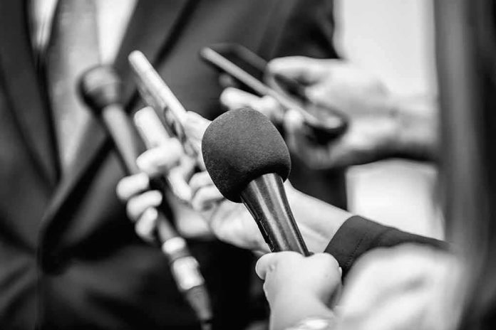 Microphones and recorders held toward a speaker
