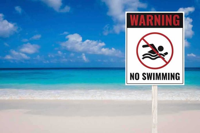 No swimming warning sign on a tropical beach