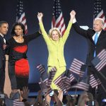 Barack Obama, Michelle Obama, Jill Biden, and Joe Biden celebrate on stage with U.S. flags