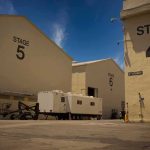 Dancers Dodge Death as Trump Fair Stage COLLAPSES! Film studio stages with numbered buildings and trailer