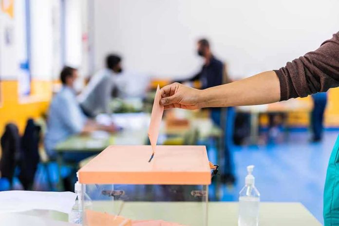 Hand casting ballot into a box at a polling station