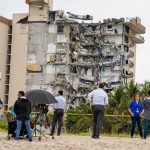 Monster Quake KILLS Dozens – Tsunami Fears! Partially collapsed beachfront apartment building with onlookers