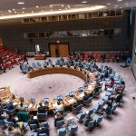 Muslim Mayor SECRETLY Meets Iran Leaders Delegates seated around a circular conference table in a large chamber