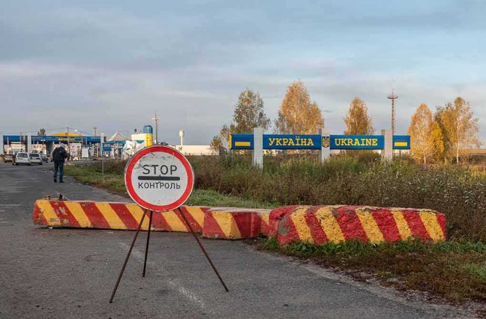 shutterstock_2065835399 Ukraine border crossing with stop sign and barrier