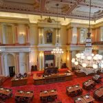 UFO Cover-Up FINALLY Exposed! Legislative chamber with red carpet and chandeliers