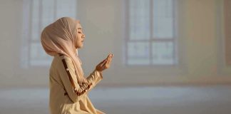 Another Country BANS Burqas From Public Squares Woman in hijab praying on a mat indoors