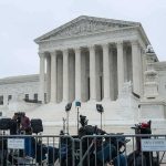 U.S. Supreme Court building with media equipment set up outside