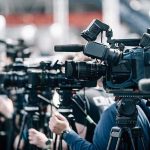 Police Raid Opposition HQ: Tear Gas Chaos Broadcast cameras on tripods at a press event