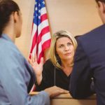 Illegal Alien KIDNAPS Special Needs Kid! Judge speaking with two attorneys at the bench in a courtroom