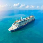 Cruise ship sailing on calm turquoise sea