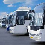 Row of modern coach buses parked in a line