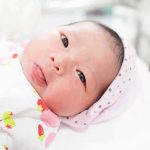 newborn baby lying on a blanket