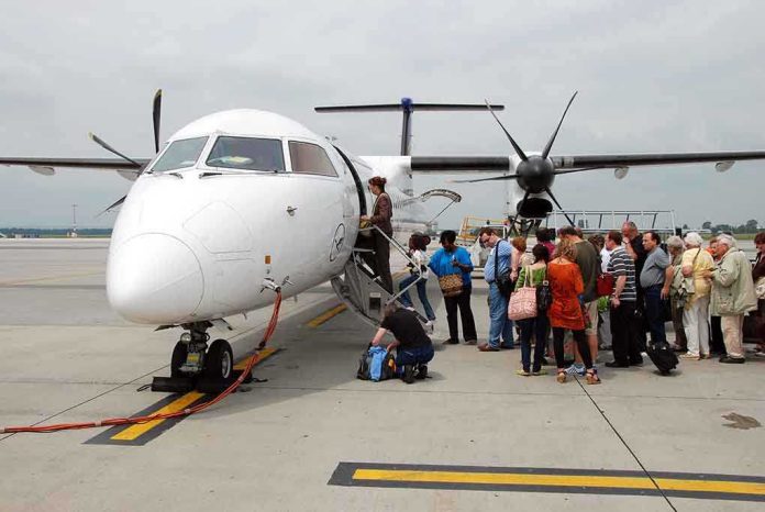 Passengers boarding a white turboprop airplane on the tarmac